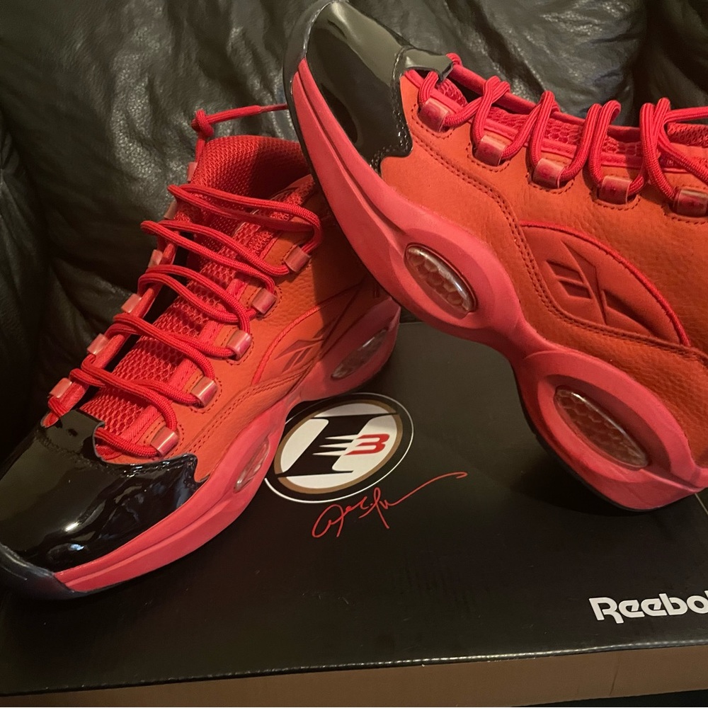Allen Iverson Reebok THE QUESTION mid. Red and has black patent leather toe.